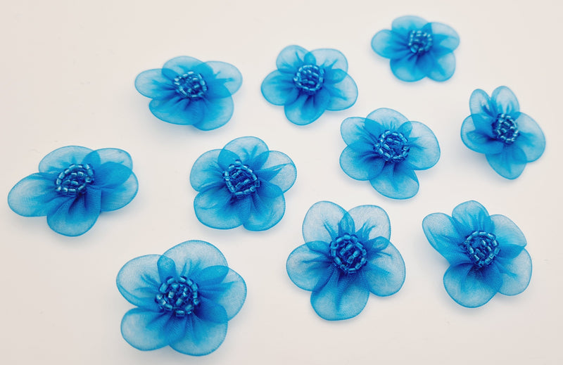 Petites fleurs bleu turquoise par 10